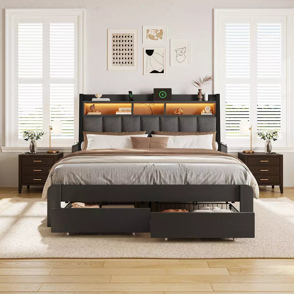 Bedroom with a black bed frame featuring storage drawers, wooden flooring, and white walls.