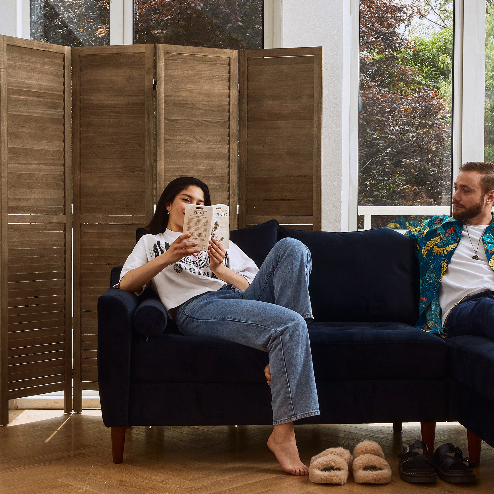 Dark brown wood privacy screen used as a room divider in a master bedroom.