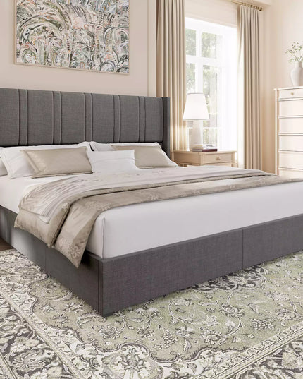 Bedroom with a gray upholstered bed, white bedding, and decorative elements.