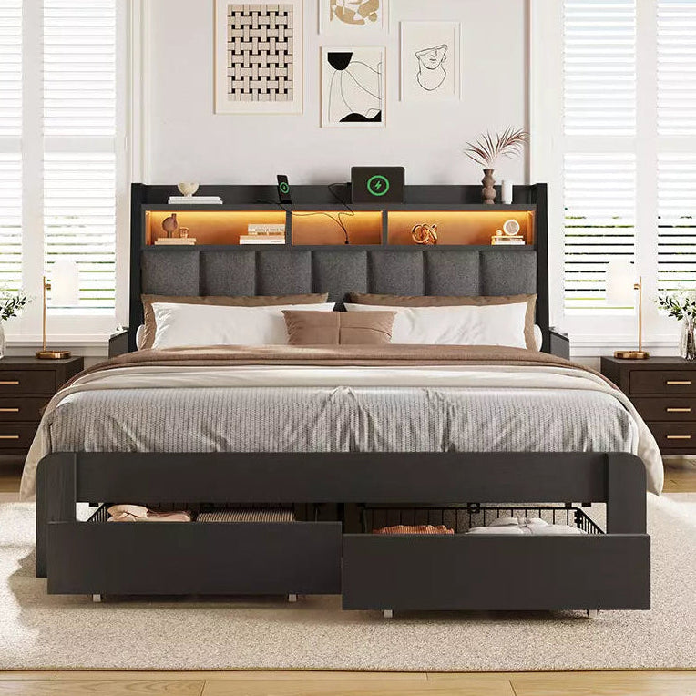 Bedroom with a black bed frame featuring storage drawers, wooden flooring, and white walls.