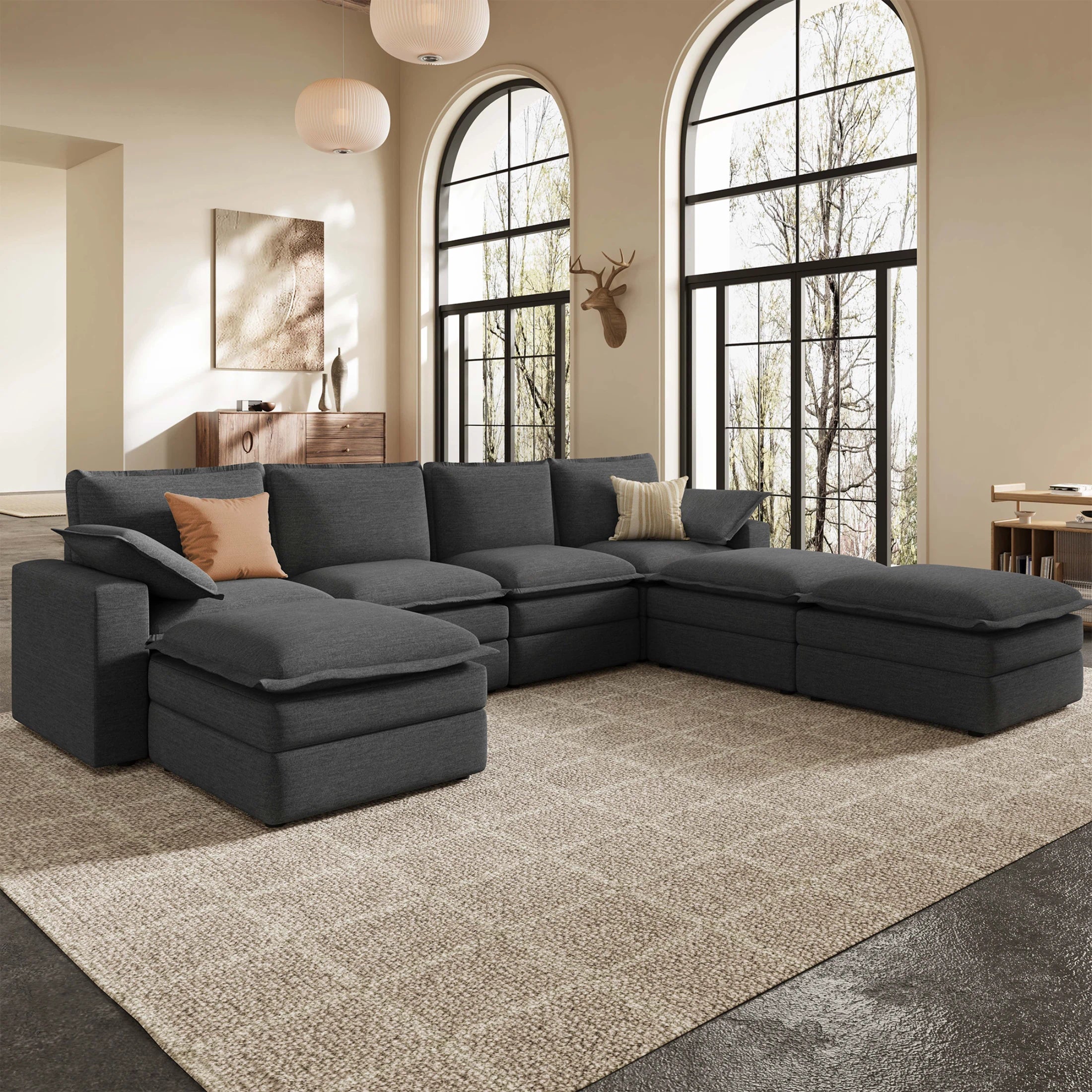 Densa 125" modular U-shaped cloud sofa in dark gray polyester, 7-seater sectional for a modern living room with large windows.