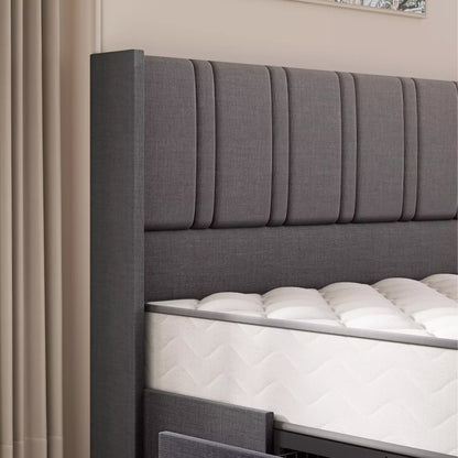 Gray upholstered headboard with white mattress in a bedroom setting
