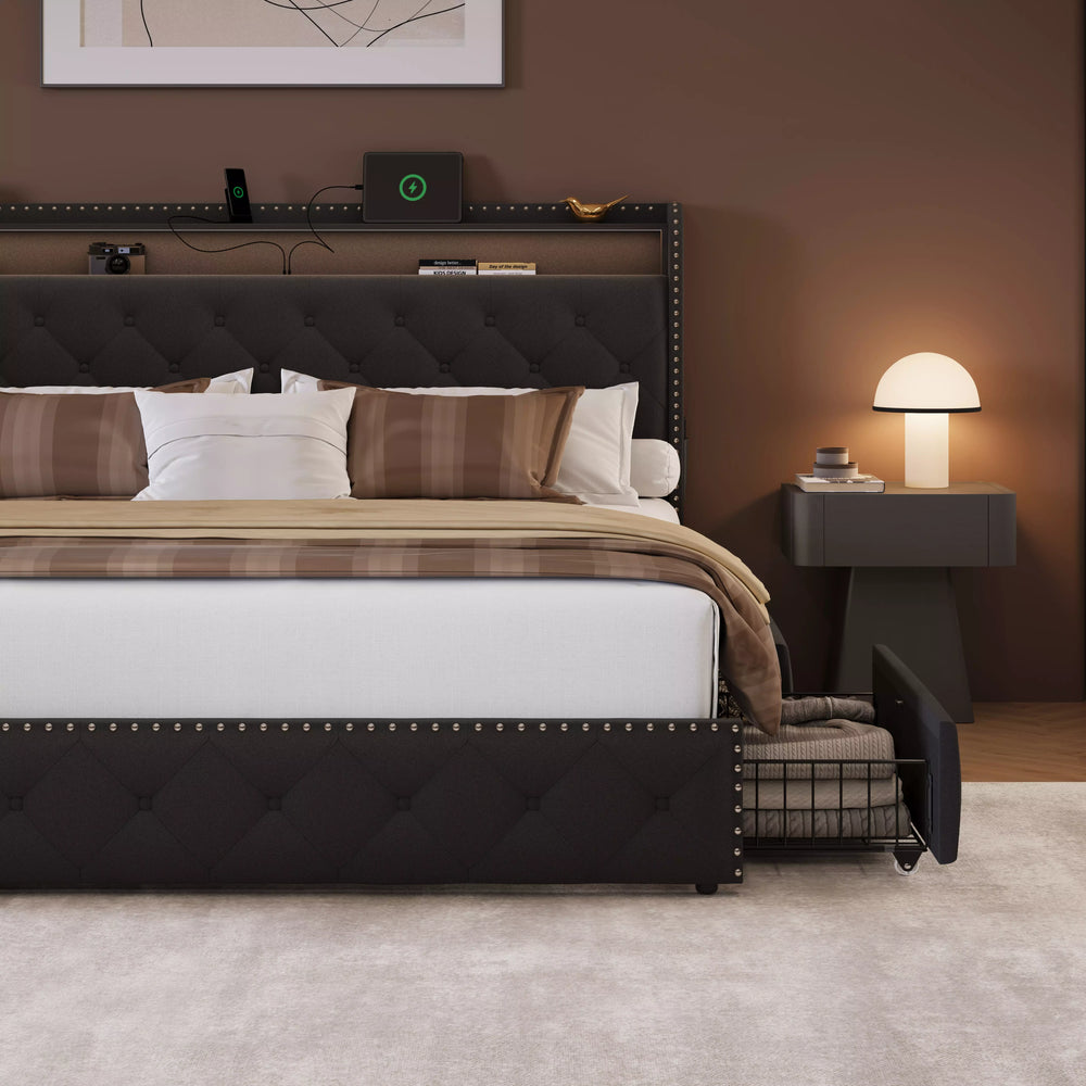Modern bedroom with a black upholstered bed, nightstand, and lamp.