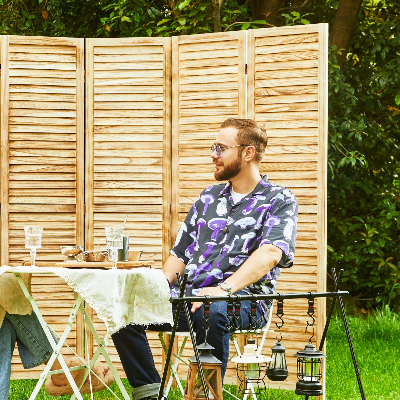 Natural wooden slats room separator allowing sunlight to pass through in a sunroom