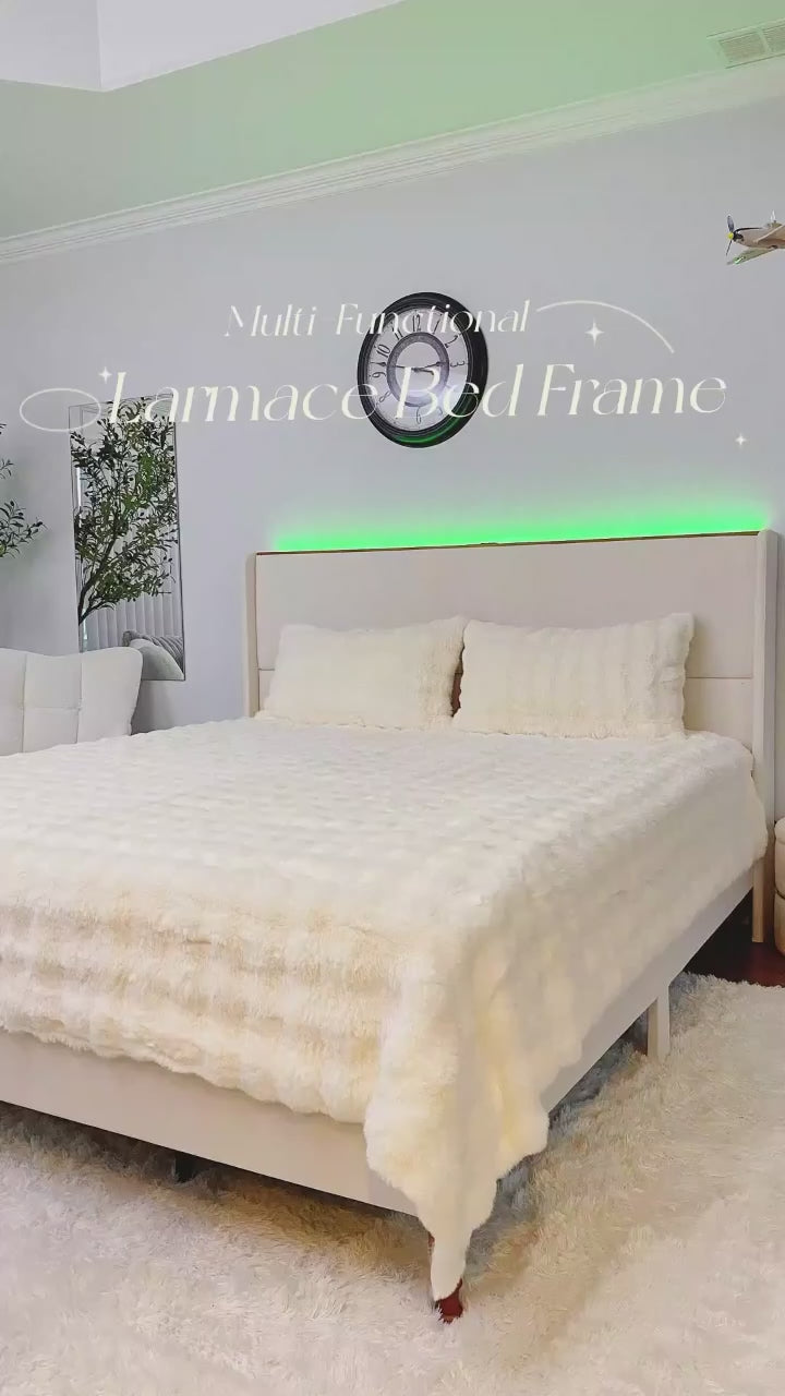 Load video: Bedroom with a bed featuring a textured white comforter, light green walls, and a decorative wall clock.