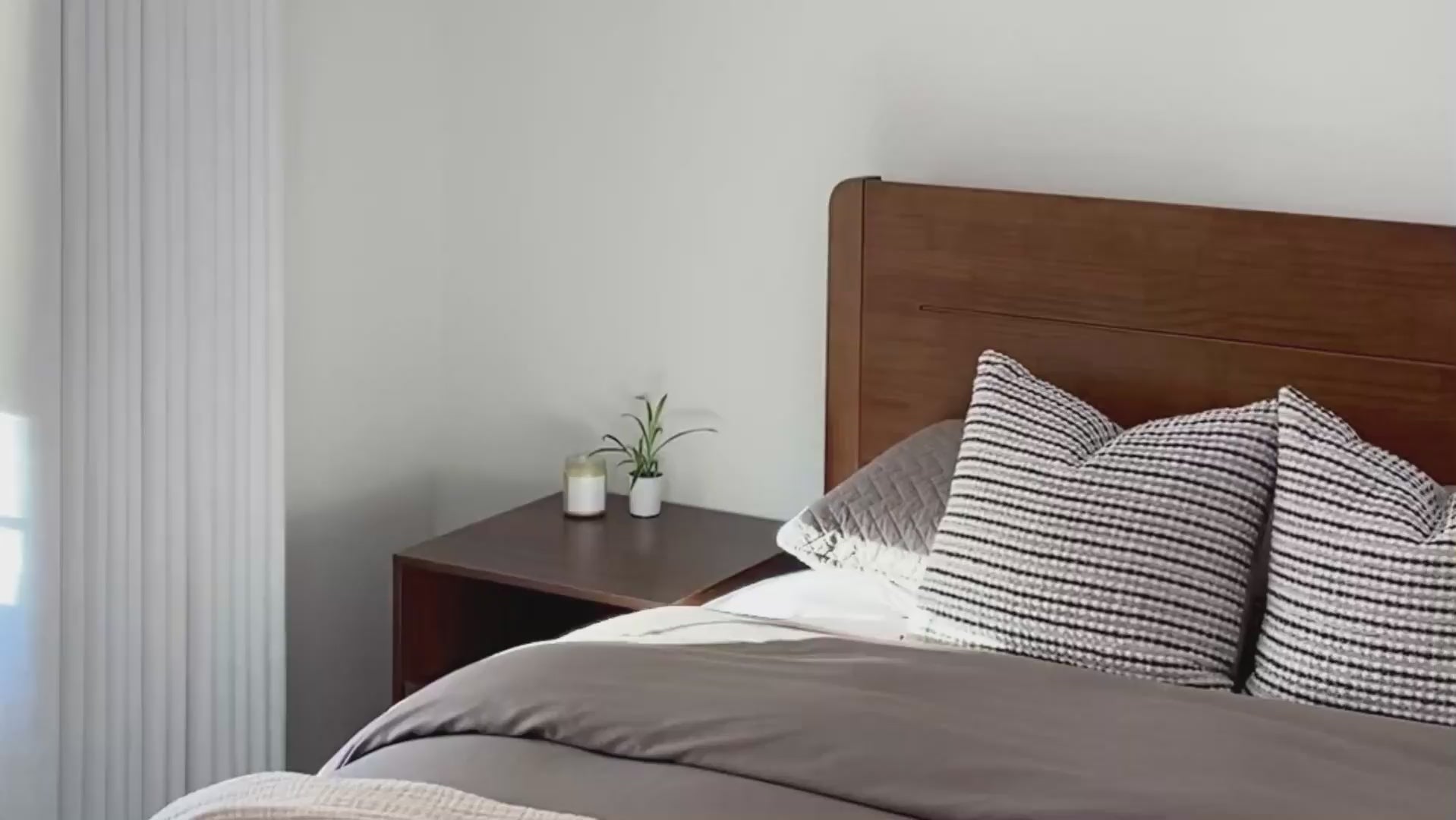 Load video: Real home video of Sorel Japandi solid wood platform bed frame in Walnut finish with headboard shelf and bedside styling