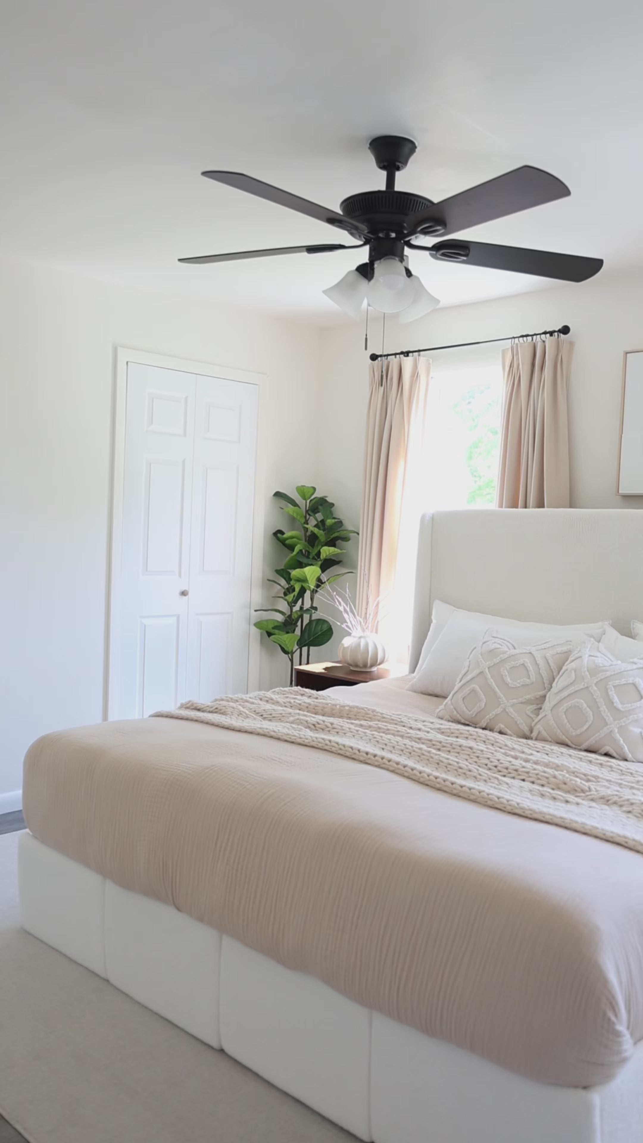 Load video: KOL lifestyle video featuring a refined solo living woman with a king size white sherpa platform bed frame in a cozy modern bedroom.