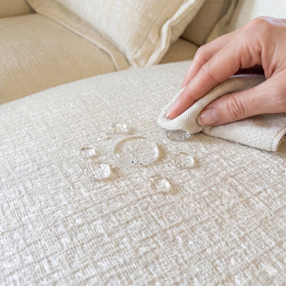 Water-repellent fabric test on the dark gray u shape sectional sofa, a durable 7 seater modular set with stain-resistant movable ottomans.